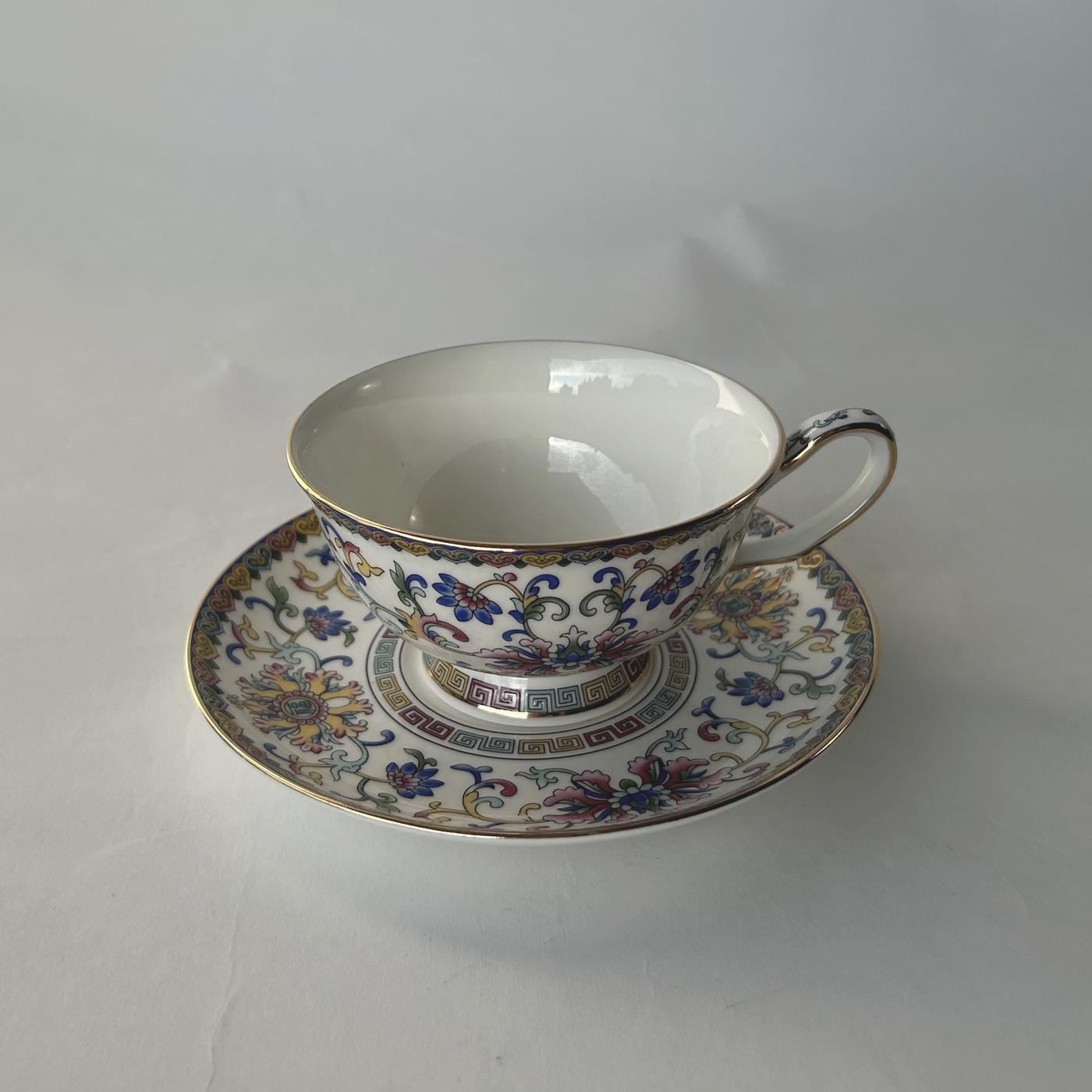 Ceramic famille rose enamel tea cup and saucer